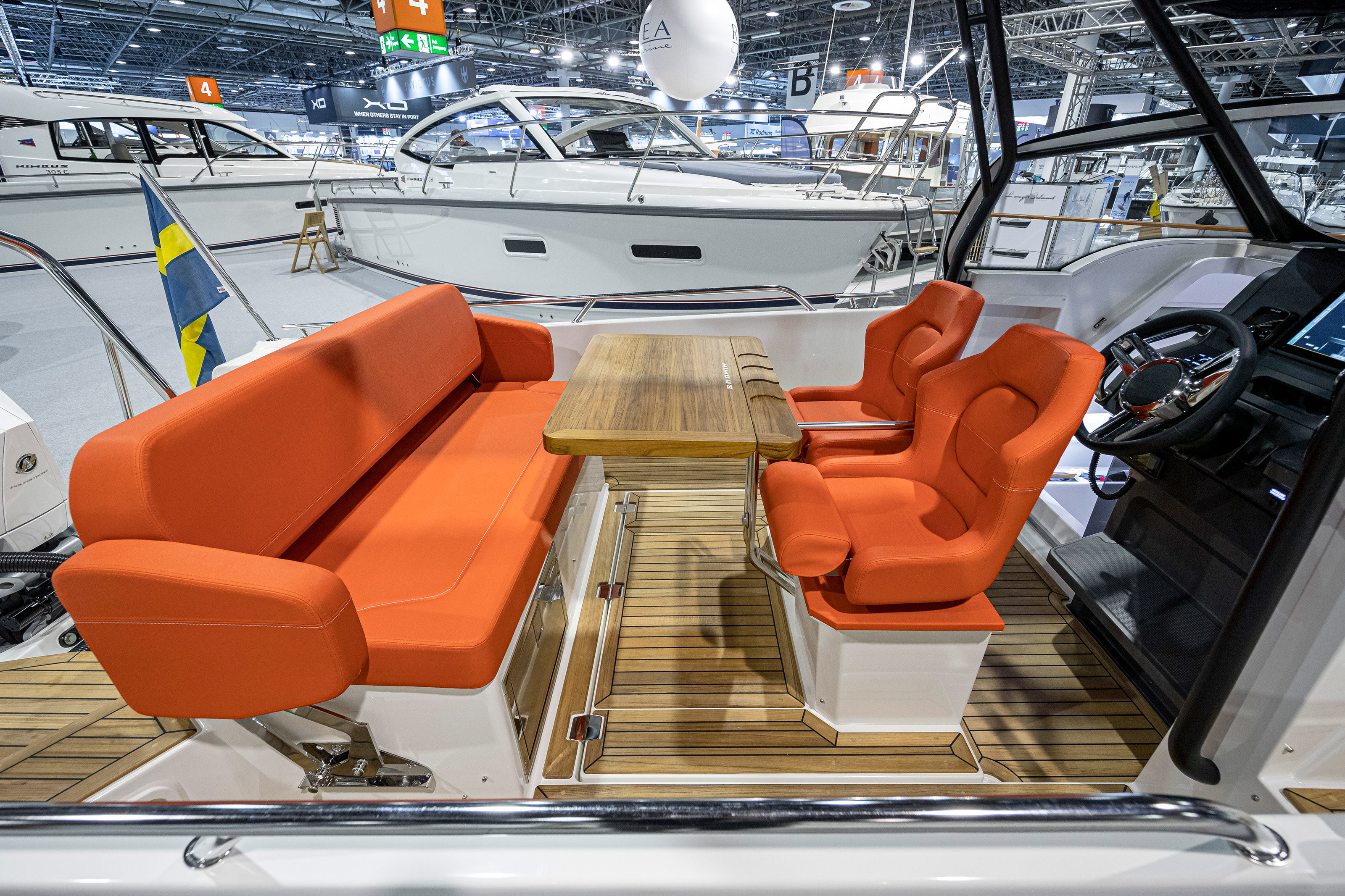 A table on a boat with orange seats